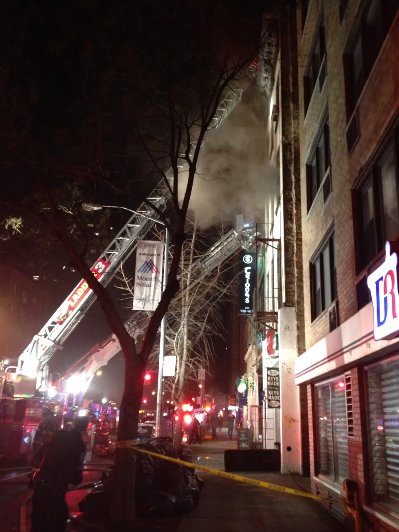 Fire trucks and smoke outside the School For The Dogs studio building on Third Avenue the night of the fire
