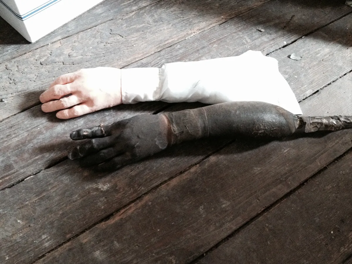A rubber Assess-A-Hand lying on the burned floor