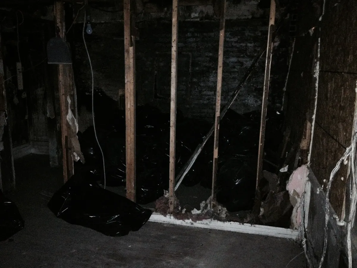 The burned-out interior of the Third Avenue studio, stripped to the wall studs