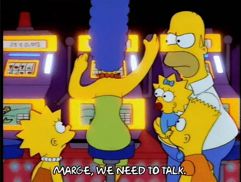 Marge, Homer and Lisa Simpson at a slot machine, captioned "Marge, we need to talk"